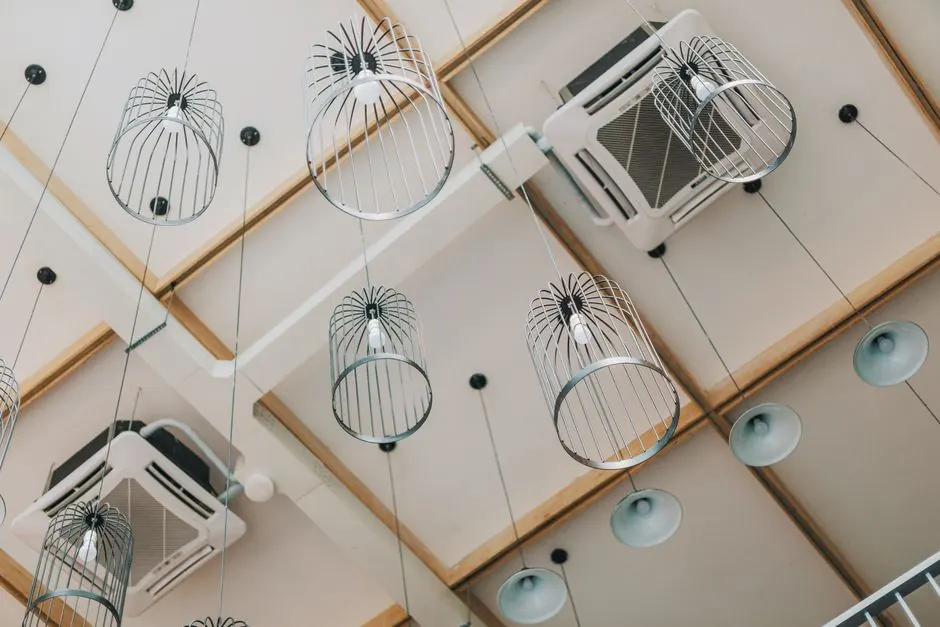 Low angle view of modern pendant lamps in a contemporary interior with a uniquely designed ceiling.